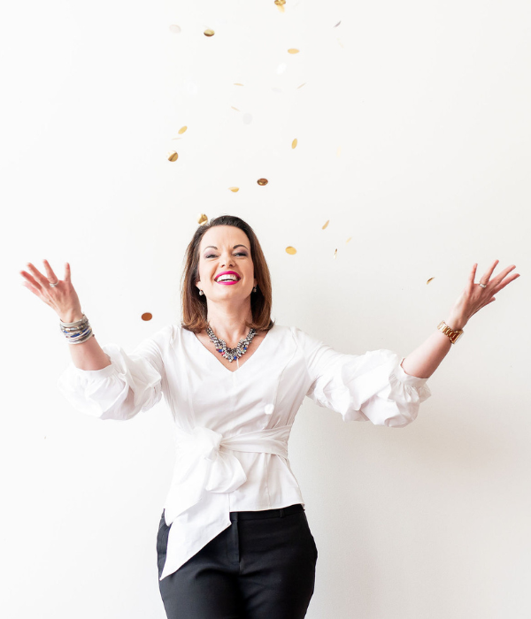 Empowered woman celebrating success with confetti at an event, symbolizing resilience and hope.