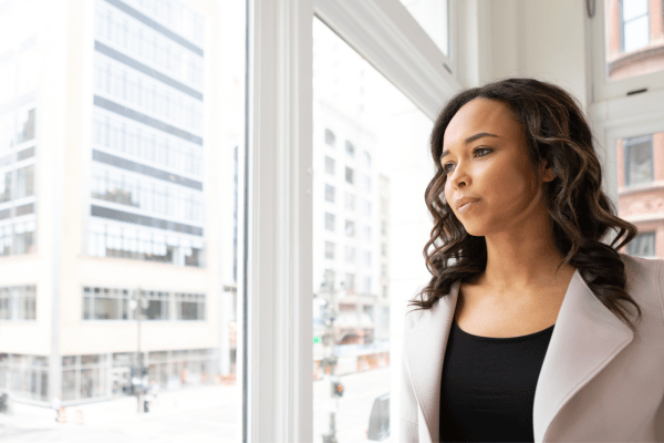 woman looking out the window, serious expression